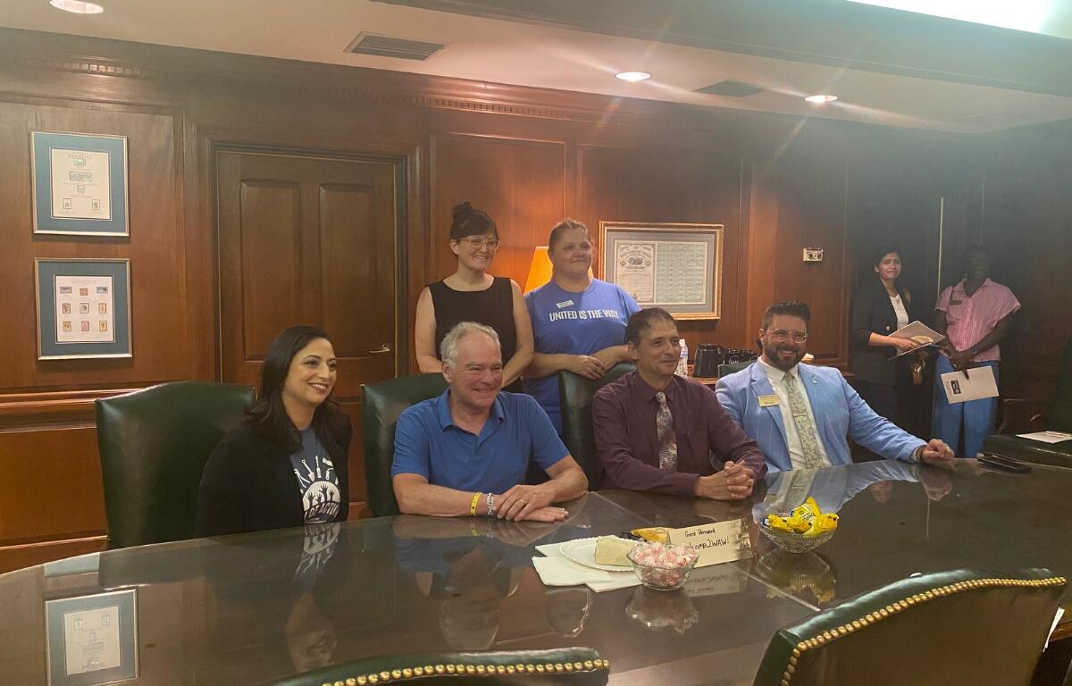 Senator Tim Kaine sits with United Way of the Central Shenandoah Valley board members and employees.