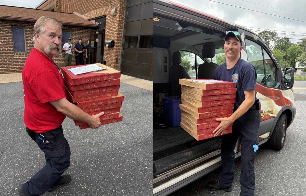 Harrisonburg Fire Department firefighters carry pizza boxes.