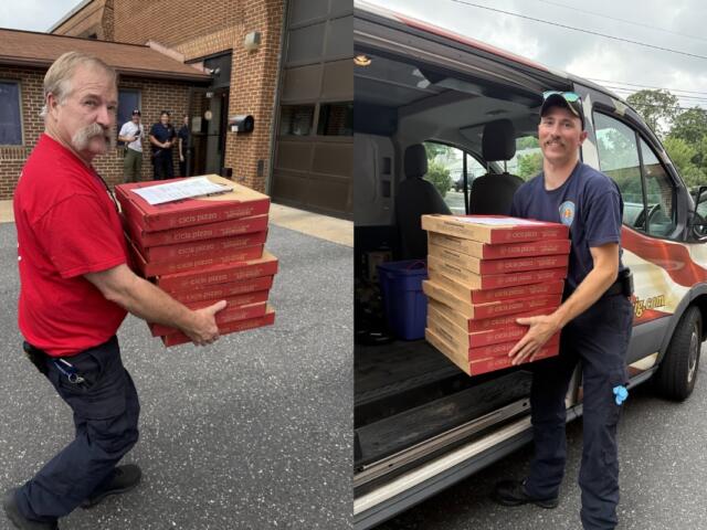 Harrisonburg Fire Department firefighters carry pizza boxes.