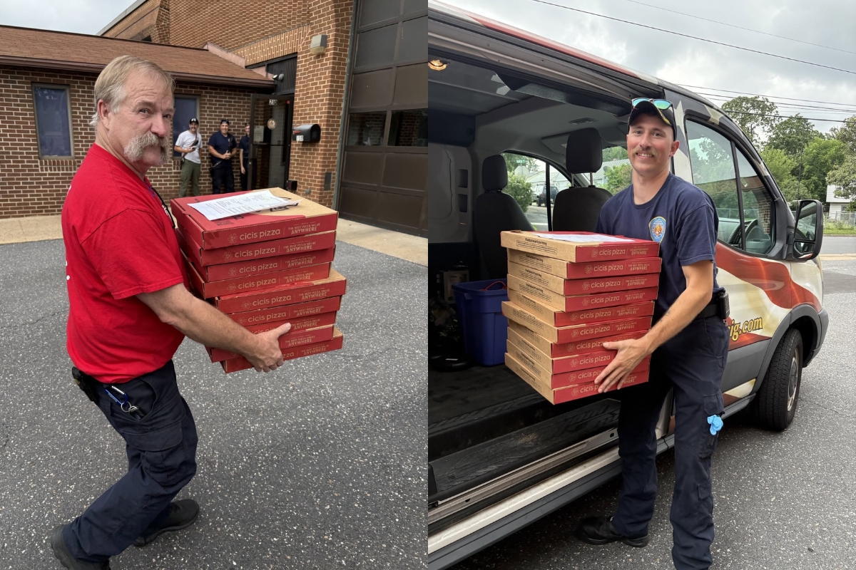 Harrisonburg Fire Department firefighters carry pizza boxes.