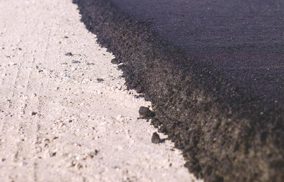 Up close of pavement being laid.