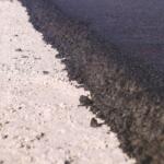Up close of pavement being laid.