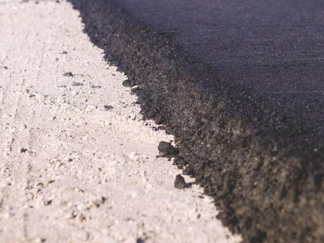 Up close of pavement being laid.