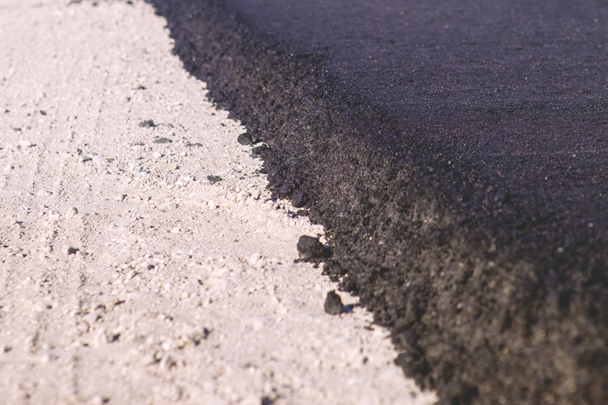 Up close of pavement being laid.