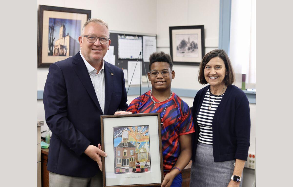 Marquel Ocheltree holding artwork with Clerk Haywood