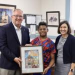 Marquel Ocheltree holding artwork with Clerk Haywood