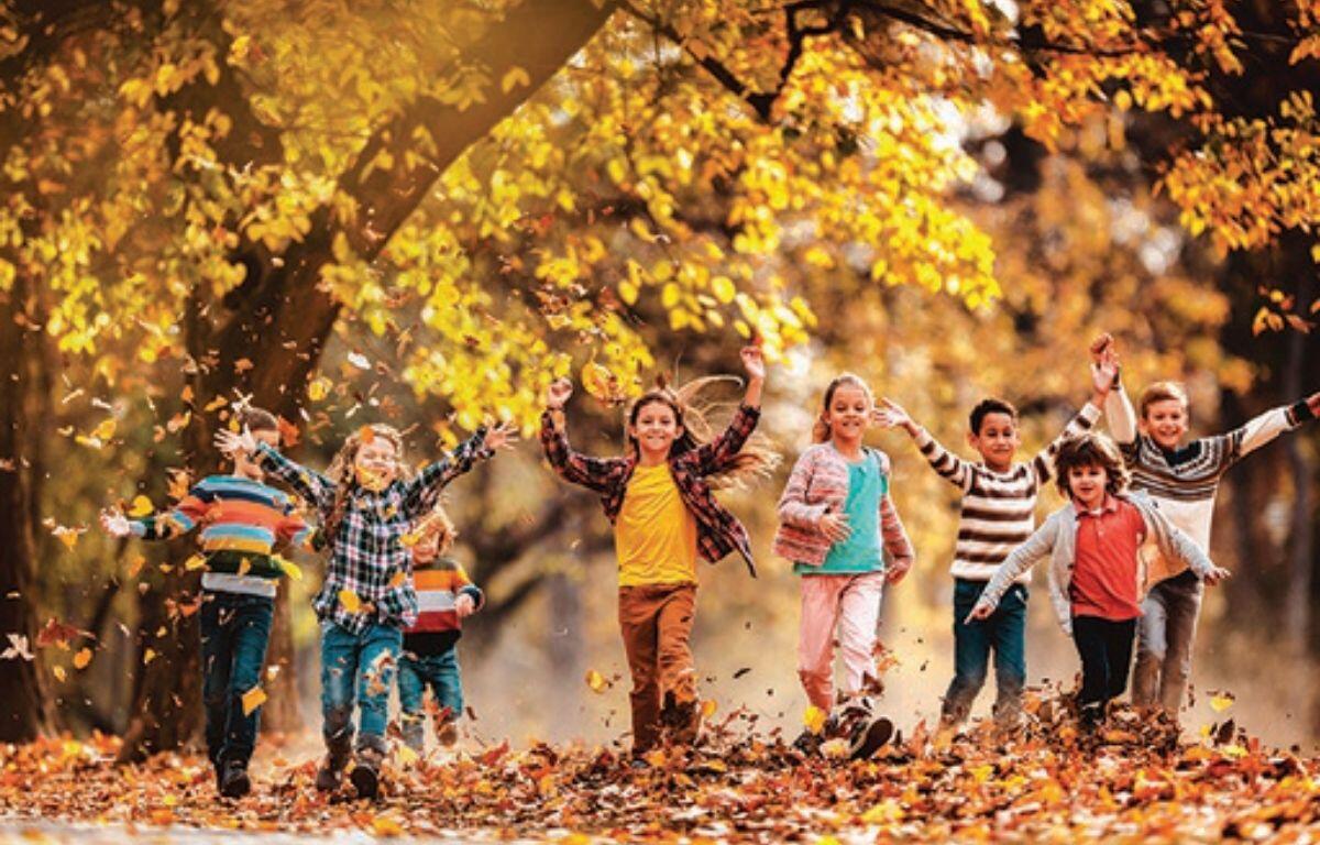 Kids playing in the fall leaves