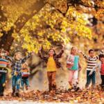 Kids playing in the fall leaves