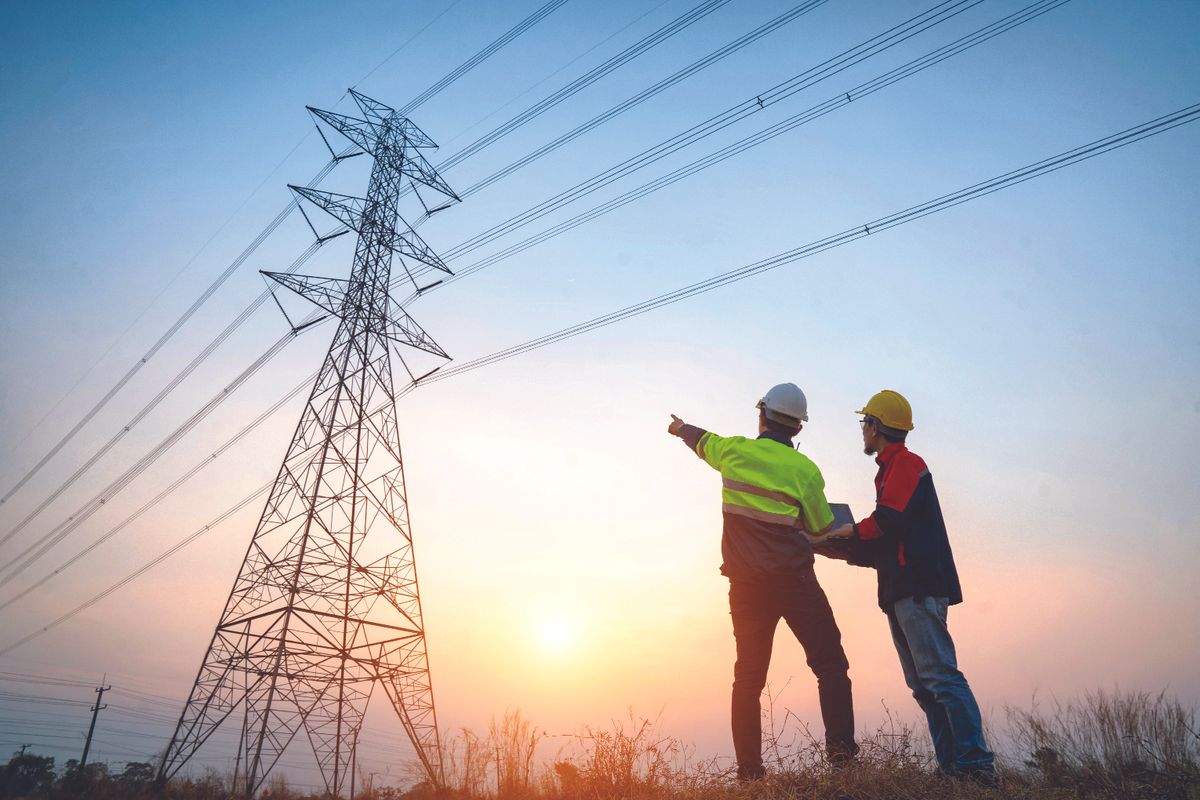 Workers looking at power lines
