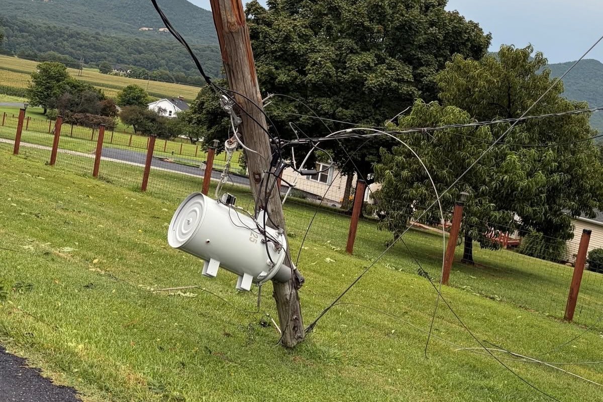 A transformer dangles from a pole in Page County, after strong winds snapped the pole.