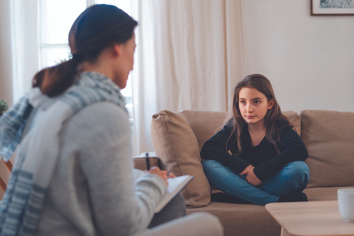 Child and counselor talking